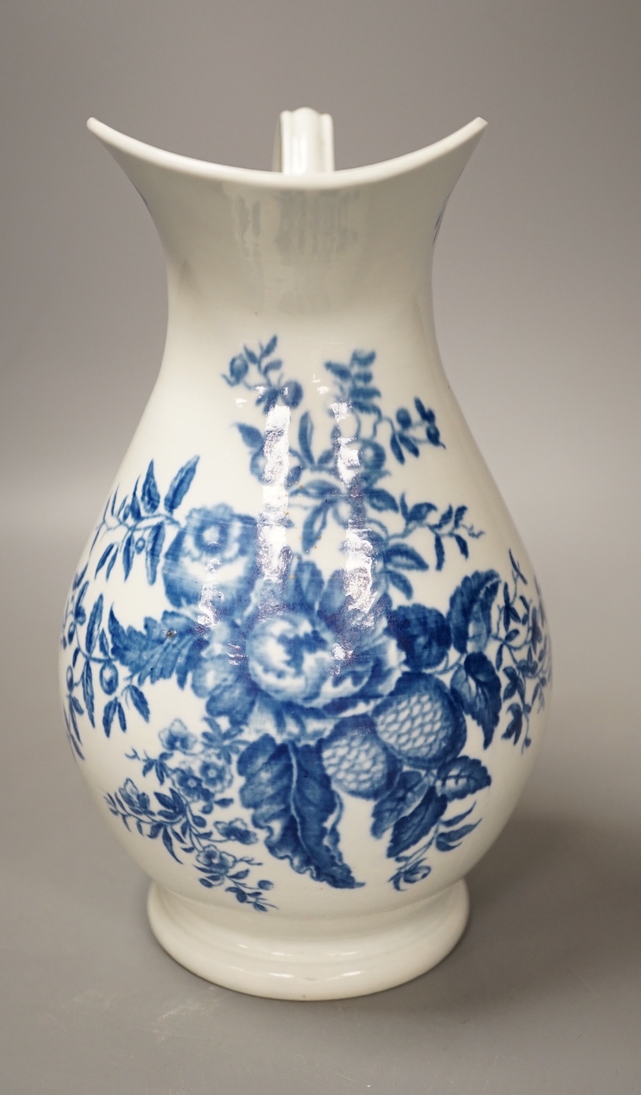 A Worcester French style water ewer decorated in under-glaze blue with fir cones and rose hips c. 1775, 21cm